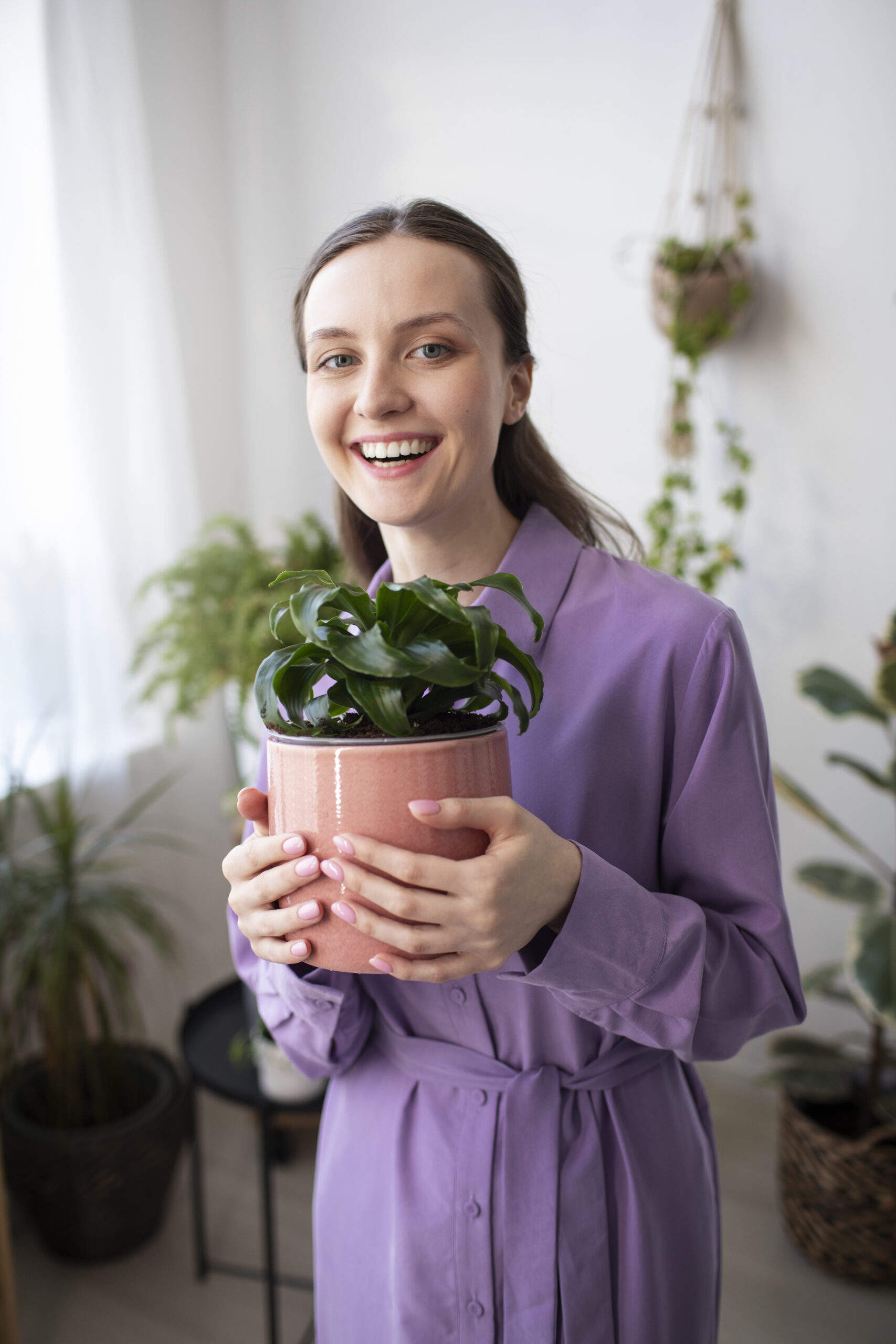 medium-shot-smiley-woman-holding-plant